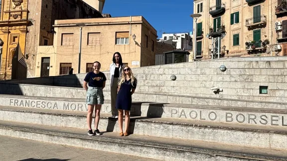 Trzy studentki stoją na schodach, na których są nazwiska zabitych sędziów walczących przeciwko Cosa Nostrze
