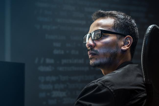 man-analysing-binary-code-virtual-screen